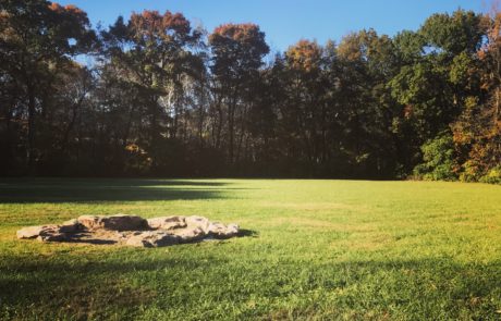 Fire pit on lawn near barn